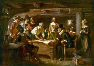 1899 painting of the signing the Mayflower Covenant with 41 of the ship's 101 passengers; the Mayflower was anchored in Provincetown Harbor within the hook at the northern tip of Cape Cod.